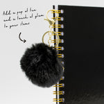 Black faux fur attached to hardcover notebook binding
